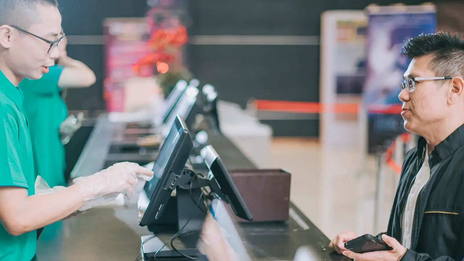 Un client interagit avec un caissier au comptoir.